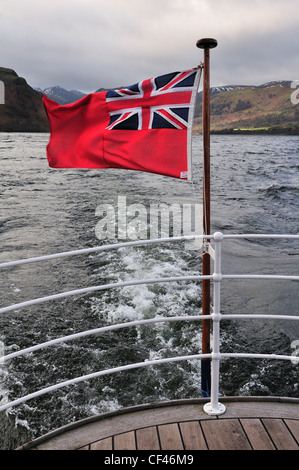 Red ensign or Red Duster flying on ferry crossing Ullswater Lake from Glenridding to Pooley Bridge,Lake District,Cumbria,UK Stock Photo