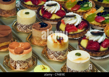 Pastries, cakes and fruit pies on display in pastry shop Stock Photo