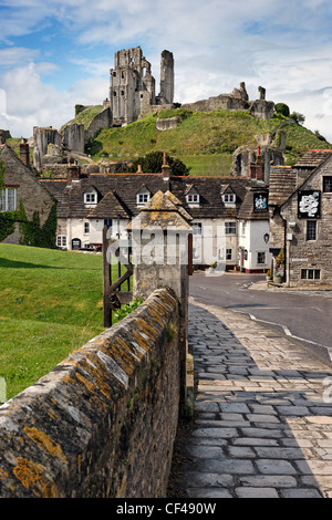 Corfe Castle overlooking the Bankes Arms Hotel in the village below. Stock Photo