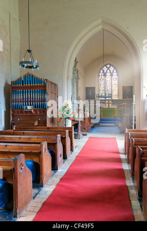 The aisle and pews inside St Mary the Virgin. The church is home to a number of outstanding medieval wall paintings dating from Stock Photo
