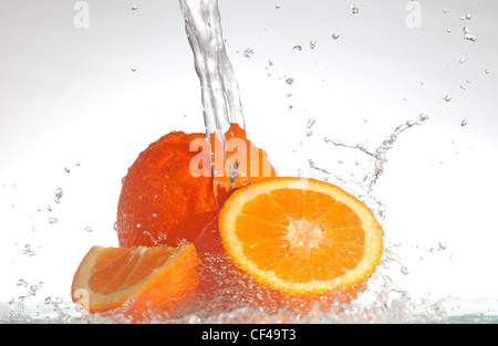 oranges splashed with water Stock Photo
