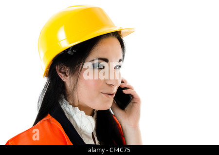 Young woman in yellow helmet talking on the phone Stock Photo