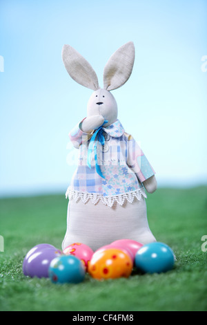 Vertical shot of an Easter bunny with eggs lying in front of it Stock Photo