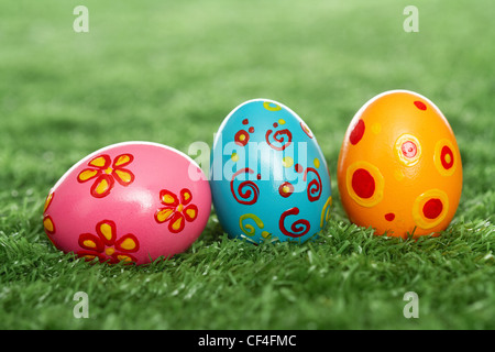 Three Easter eggs lying on the lawn Stock Photo