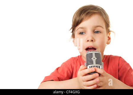 pretty little girl in red sing in old style microphone isolated on white background Stock Photo