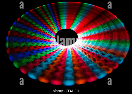 Colorful glowing trail rotating LED, in form of two cones on black ...