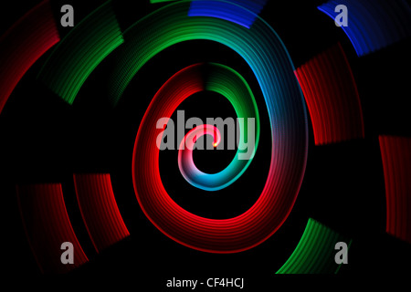 Abstract multicolored glowing in spiral pattern on black background. Stock Photo