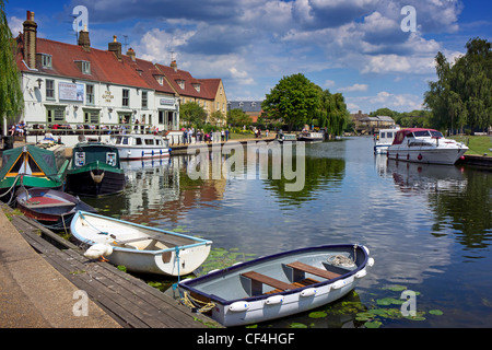 Boats moored alongside The Cutter Inn on the River Great Ouse in Ely. Stock Photo