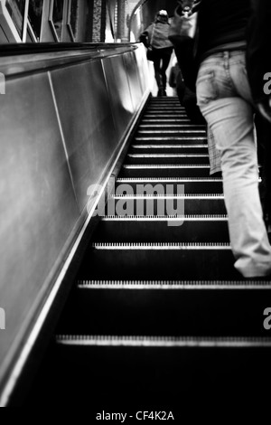 People standing on an escalator in a London Underground station. Stock Photo