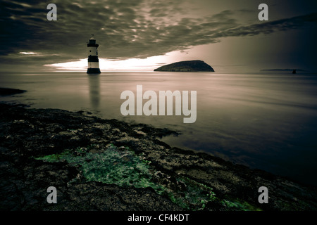 Penmon lighthouse and Puffin Island at Penmon Point on the Isle of Anglesey. Stock Photo