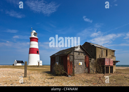 Ramshackle outbuildings next to Orfordness lighthouse on the Suffolk coast. Stock Photo