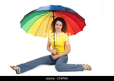 young attractive woman in yellow shirt with multicolored umbrella sitting isolated on white legs at sides Stock Photo