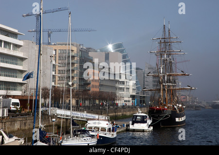 Boats and a tall ship at Dublin City Moorings on the River Liffey in the North Wall area. Stock Photo