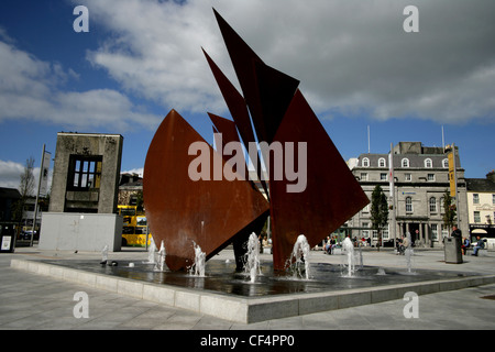 The Fountain in Eyre Square; built in 1984, consists of a copper-coloured representation of the sails of the Galway Hooker. This Stock Photo