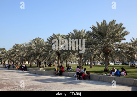 People relaxing on the corniche of Doha, Qatar Stock Photo