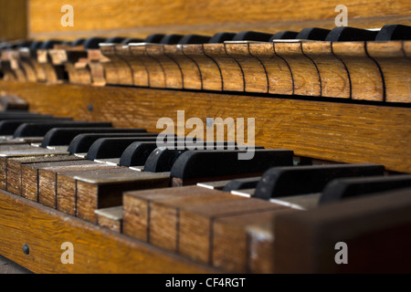 Close-up of an old organ keyboard in a derelict chapel. Stock Photo