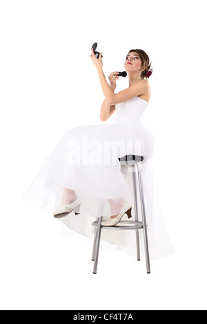 Beautiful bride with perfect skin applying make up on face with make-up brush Stock Photo