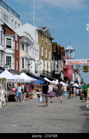 Shoppers walking along Guildford High Street. Stock Photo