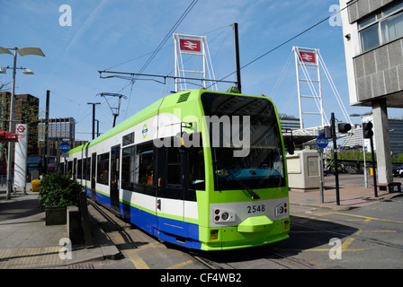A tram on Croydon Tramlink outside East Croydon Railway Station. Stock Photo