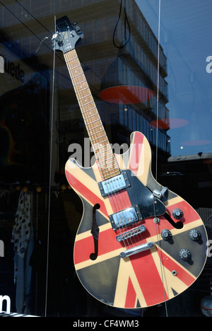 An electric guitar decorated with a Union Jack in a shop window. Stock Photo