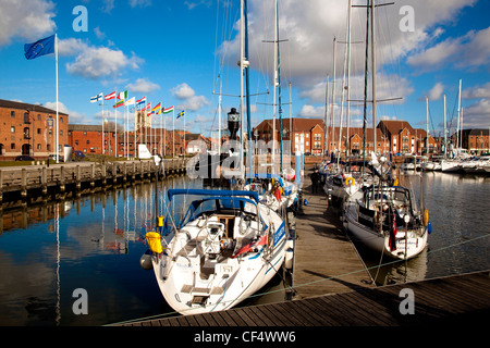 Boats moored either side of a jetty in Hull Marina. Stock Photo