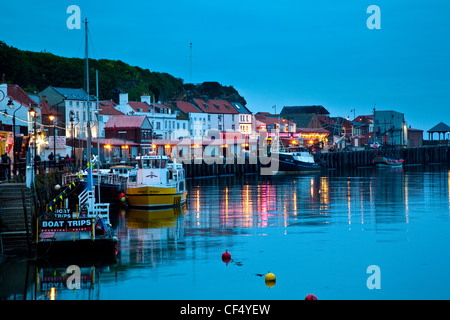Pleasure boats moored in Whitby lower harbour at dusk. Stock Photo