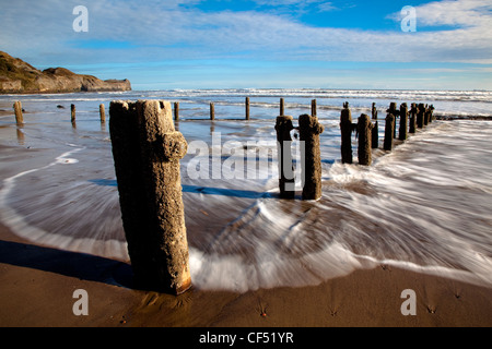 Waves from the North sea washing onto the shore around Groynes on Sandsend beach near Whitby on the North Yorkshire Coast. Stock Photo