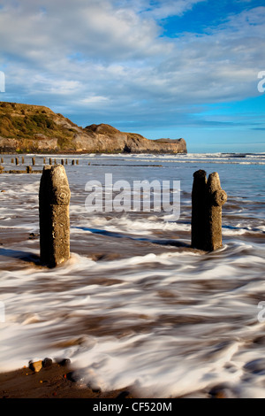 Waves from the North sea washing onto the shore around Groynes on Sandsend beach near Whitby on the North Yorkshire Coast. Stock Photo