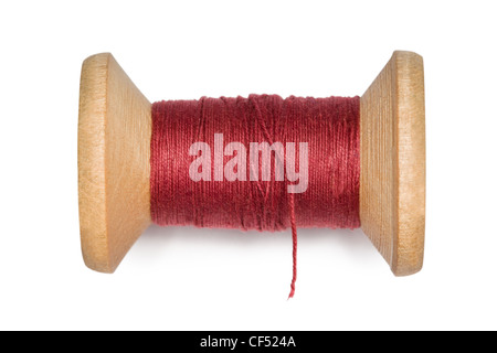 wooden coil with red threads isolated on white background Stock Photo