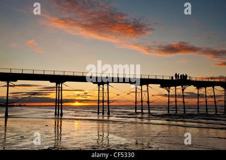 Sunset over the Victorian pier at Saltburn-By-The-Sea, the first and last on the North East coast. Stock Photo