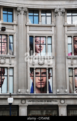 Giant pictures of faces in United Colors of Benetton store in Oxford Street. Stock Photo