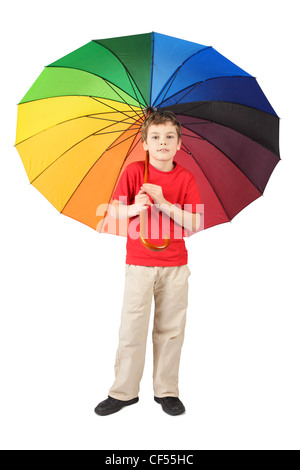 little boy in red shirt with big multicolored umbrella standing on white Stock Photo