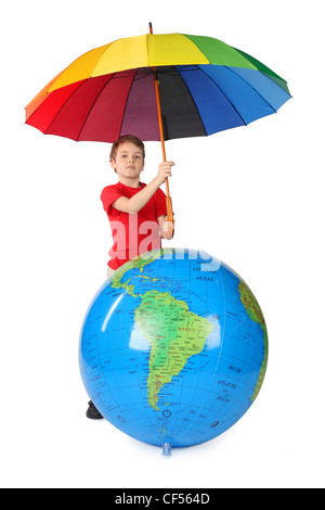 boy in red shirt with multicolored umbrella and inflatable globe isolated on white Stock Photo