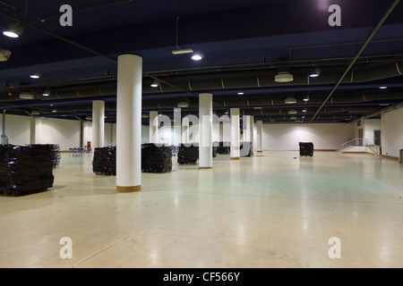 Large, empty warehouse. Ventilation and lighting equipment is mounted on ceiling. Stock Photo