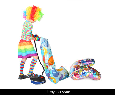 boy in clown dress pupming birthday balloons isolated on white background Stock Photo