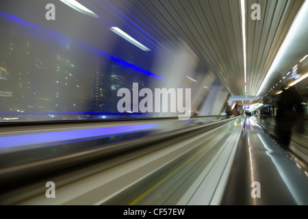 blured abstract view from window in long corridor in modern building on night city Stock Photo