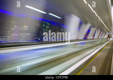 blured abstract view from window in long corridor in modern building on night city Stock Photo