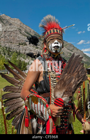 Waterton Lakes National Park Blackfoot head dancer Aryson Black Plume in full regalia and face paint at the Blackfoot Arts & Stock Photo