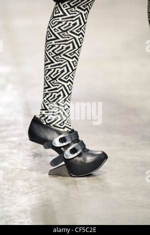 Gareth Pugh London Ready to Wear Autumn Winter Black and white patterned tights, black shoes buckles and unusual silver wedge Stock Photo