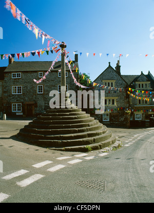 The Market Cross and King's Head pub decorated with bunting for the village well dressings in August. Stock Photo