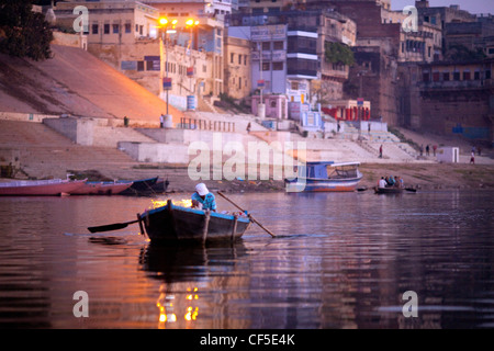 A boat on the ganges beside Varanasi ghats at sunrise, India Stock Photo