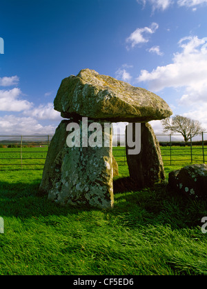 The exposed remains of a Neolithic burial chamber in Llanidan parish; three side-slabs support a sloping capstone. Stock Photo