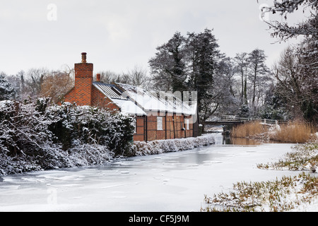 Snowy landscape in Surrey, UK, on River Wey, with snow on frozen surface, near Pyrford Stock Photo