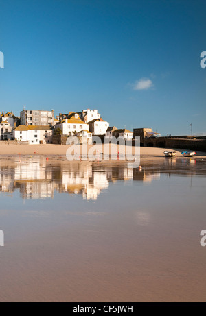 Buildings reflected in the low tide at St. Ives. Stock Photo