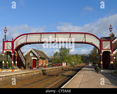 Footbridge across the railway tracks at Settle station in Ribblesdale on the Settle-Carlisle Line. Stock Photo