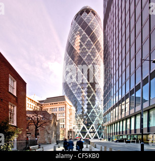 Partial view of 30 St Mary Axe building. Infamously known as 'the Gherkin' due to its 3D oval shape, it is one of the first land Stock Photo