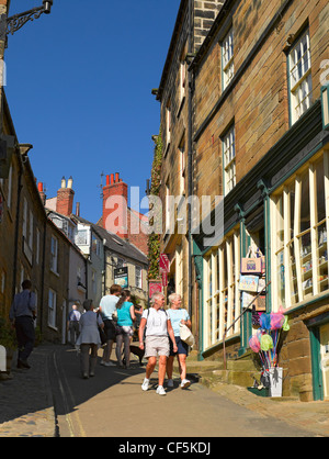 People walking up and down King Street in Robin Hoods Bay, the busiest smuggling community on the Yorkshire coast during the 18t Stock Photo