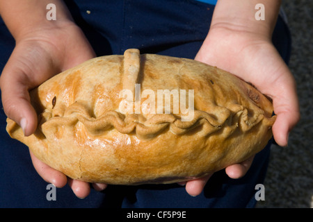 A cornish pasty about to be eaten Stock Photo
