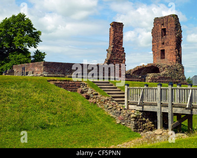 A wooden footbridge over a moat leading to the ruins of Penrith Castle, once a royal fortress for Richard, Duke of Gloucester be Stock Photo