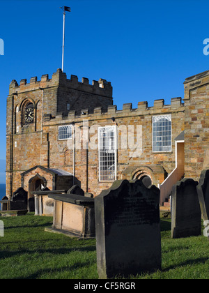 The fortress-like exterior of St. Mary's Church and churchyard at the top of 199 stone steps leading up East Cliff from the town Stock Photo
